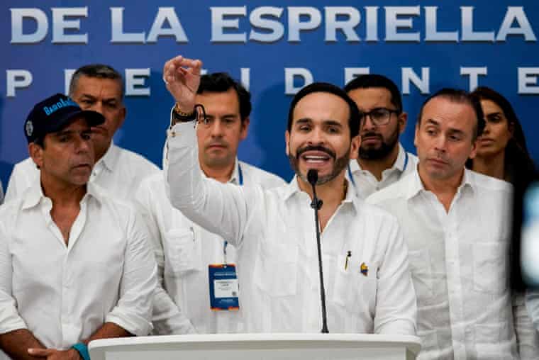 Colombia’s president-elect, Abelardo de la Espriella, dressed in white, gives a speech flanked by a group of people also dressed in white