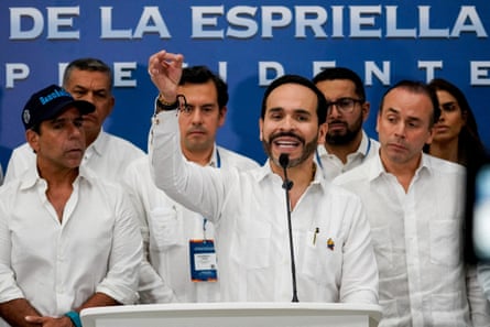 Colombia’s president-elect, Abelardo de la Espriella, dressed in white, gives a speech flanked by a group of people also dressed in white