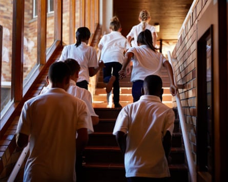 Students walking up a staircase at school
