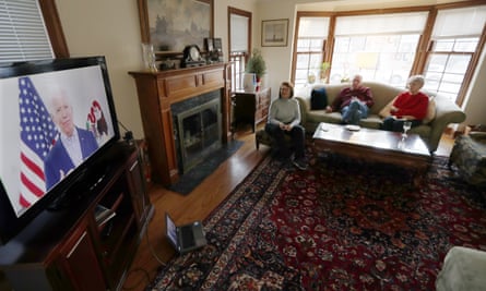 Chicago residents watch Joe Biden during his Illinois virtual town hall on 13 March.