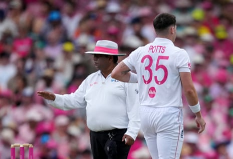 Umpire Ahsan Raza signals four runs.