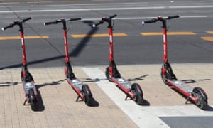 Electric rental scooters parked in a street in Chile