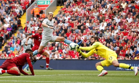 Alisson saves for Liverpool.