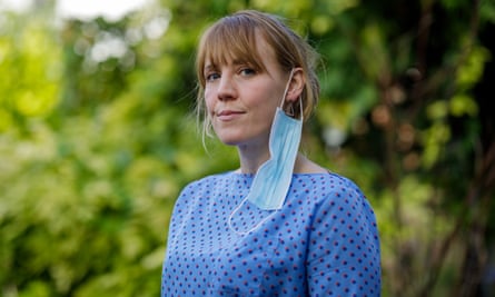 Woman with mask dangling from ear
