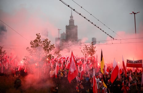 Smoke rises as people use flares during a march to mark the 107th anniversary of Polish independence, near the Palace of Culture and Science in Warsaw, Poland.