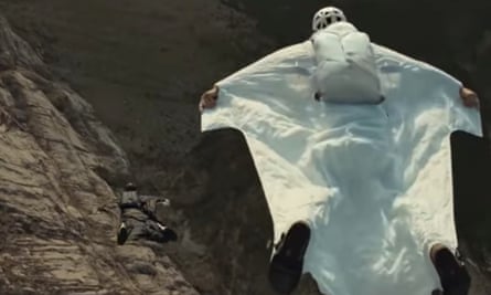 A Saudi woman wearing a wingsuit launches herself from a cliff