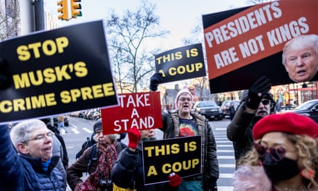 people standing outside hold signs that read 'stop Musk's crime spree' 'take a stand', 'this is a coup' and 'presidents are not kings'