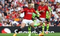 Arsenal's Bukayo Saka shoots at goal as Manchester United's Diogo Dalot attempts to block.