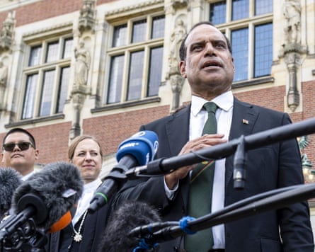 Ralph Regenvanu speaks to the press outside the court.