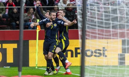 John McGinn celebrates scoring the opening goal with his teammates during the Nations League match between Poland and Scotland in Warsaw