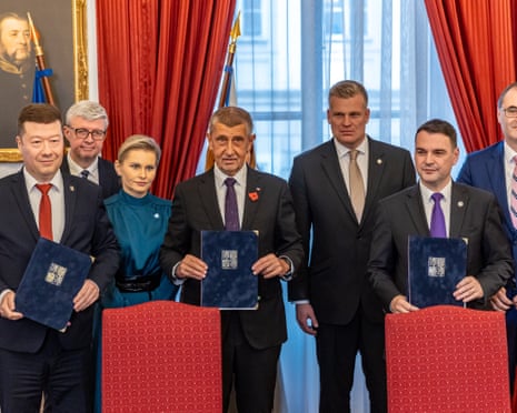 Freedom and Direct Democracy (SPD) party's chair Tomio Okamura, ANO (YES) movement's chair Andrej Babiš, and Motorists party's chair Petr Macinka pose with documents after signing a new coalition government agreement in Prague, Czech Republic.