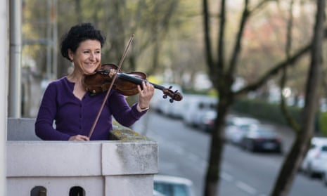 Mulhouse Symphonic Orchestra violinist Jessy Koch performs on her balcony to support health workers in Mulhouse, eastern France.