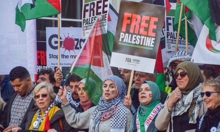 Women holding banners including one saying: ‘Free Palestine.’