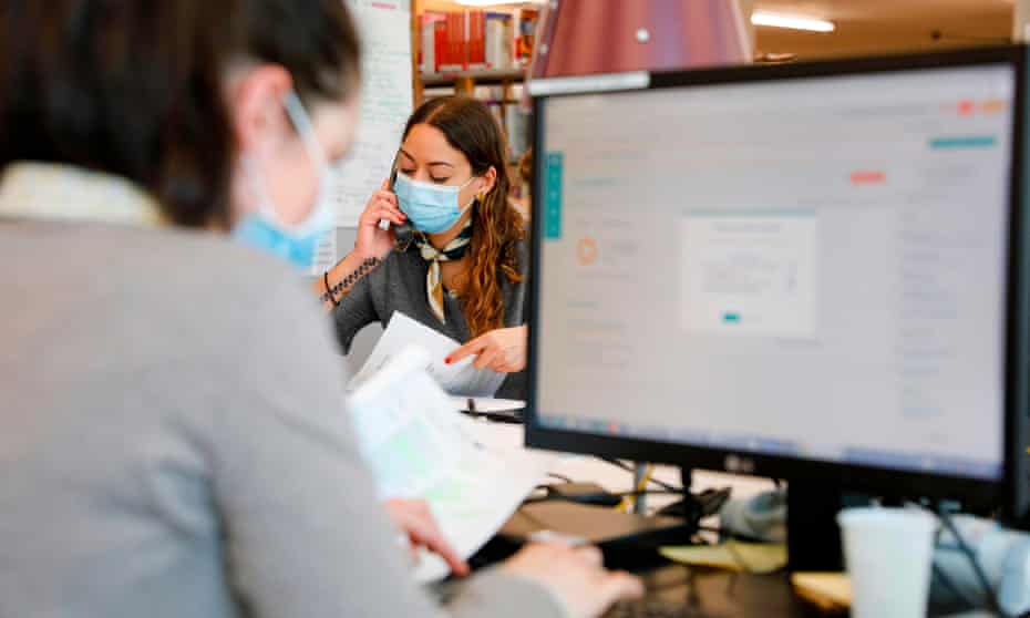 People work in a call centre of Covidom, a new remote medical monitoring app, in Paris.