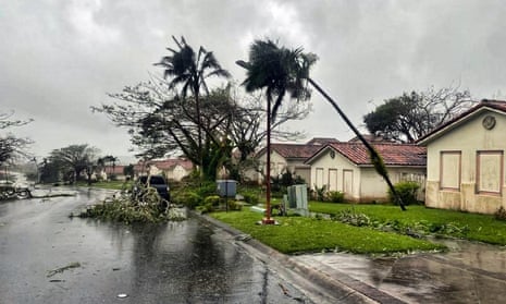 Fallen tree branches litter a neighbourhood in Yona, Guam, on Thursday