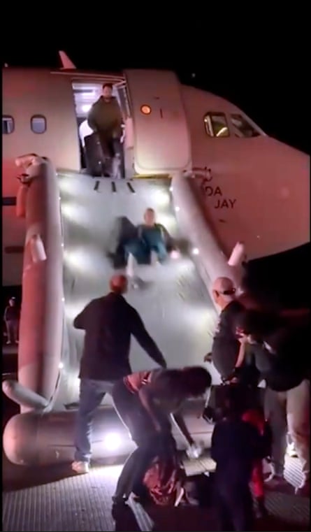 People using emergency slide to escape from an airplane