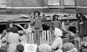 Eddie Africa uses public address system to talk to people outside the MOVE headquarters, a house in west Philadelphia, March 3, 1978.