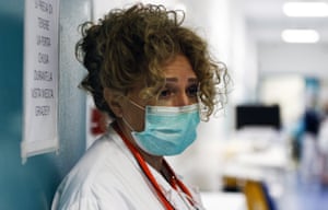 A medical staffer pauses during the coronavirus crisis at the Santo Spirito hospital in Rome,