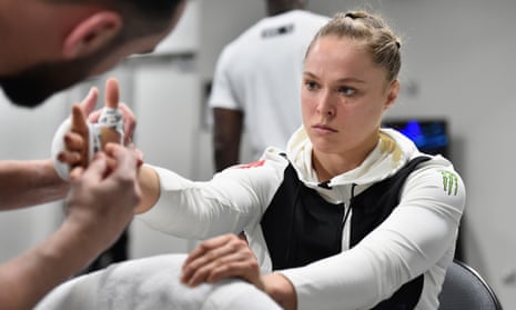 Ronda Rousey has her hands wrapped backstage.