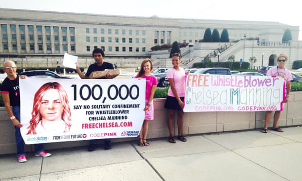 Chelsea Manning supporters hold up banners near the Pentagon before delivering more than 100,000 signatures to the US army calling for new charges to be dropped.