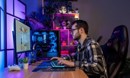 Jadun Sykes, graphic designer, Wakefield, UK, siting at a desk in front of a computer screen