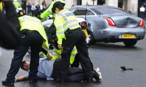 Police detain a man after the incident outside parliament