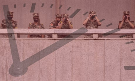 North Korean army soldiers wearing face masks look at the South side during South Korean unification minister Lee In-young's visit to Panmunjom in the Demilitarised Zone, South Korea.