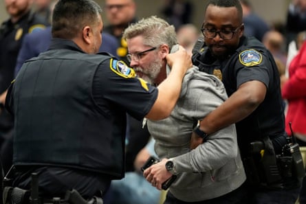 A protester is removed from Marjorie Taylor Greene’s town hall meeting in Acworth Georgia, on Tuesday.