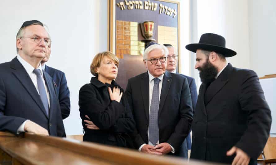 The German president, Frank-Walter Steinmeier, (second right) and his wife, Elke Buedenbender, speak with Rabbi Elisha Portnoy in Halle on Thursday.
