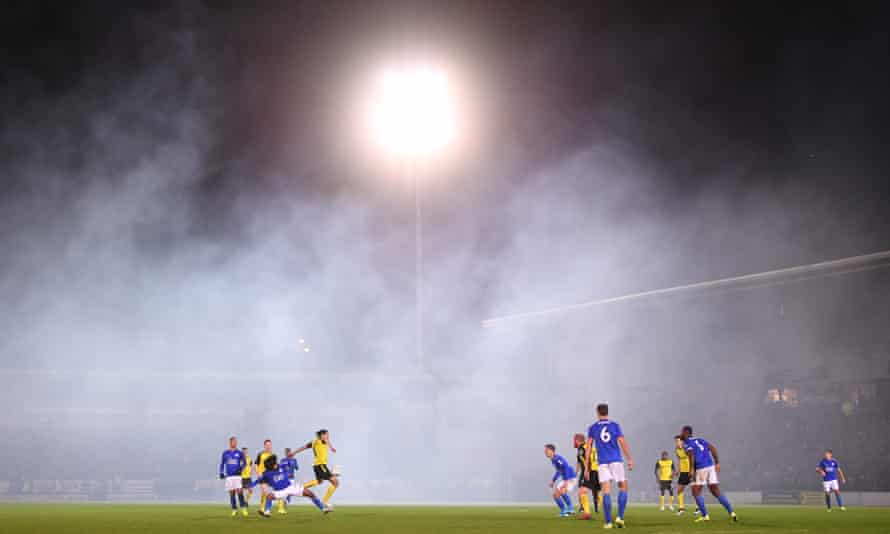 Leicester and Burton players play amid the fog.