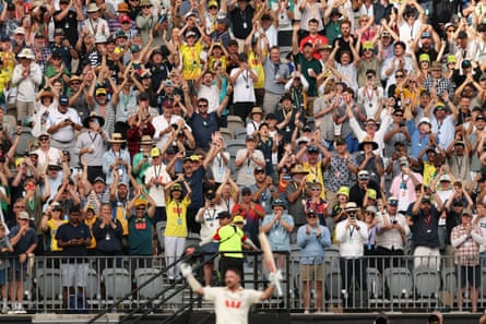 Cricket fans cheer Travis Head as he leaves the field after scoring 123 runs in the first Ashes Test in Perth