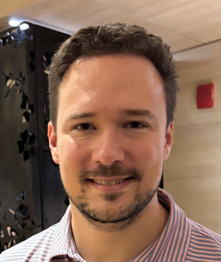A younger man smiles