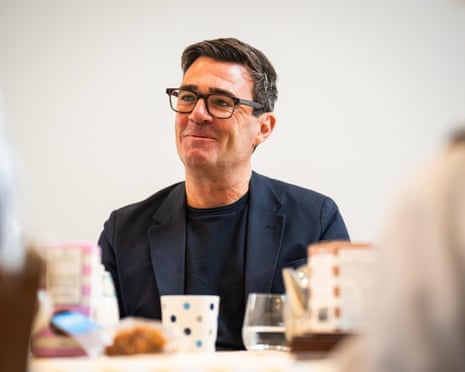 Andy Burnham sitting at a table.