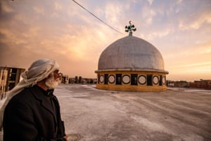 A man stares at the dome of a mosque in Raqa, Syria