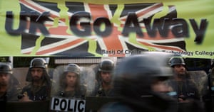 Police guard the British embassy in Tehran during a demonstration by hardline students