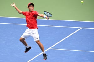 Yoshihito Nishioka hits a backhand volley .