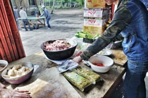 People prepare food at the camp.
