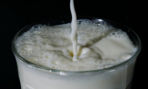 Milk splashes into a glass