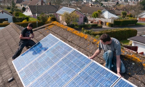 Photovoltaic solar panels being fitted to a roof.