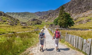 Two female hikers ascending the Watkin Path towards the summit of Snowdon.