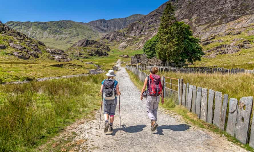 Two hikers ascending the Watkin Path towards the summit of Snowdon in Wales