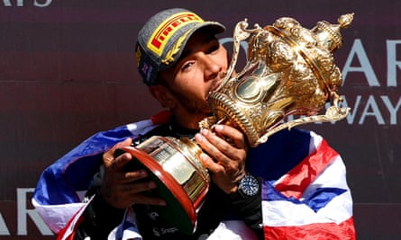 Lewis Hamilton kisses a trophy