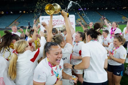 The England players show their joy on the pitch with the World Cup trophy and champagne.