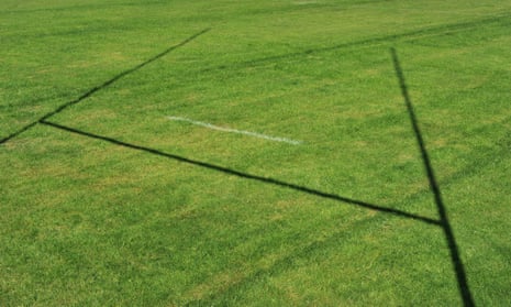 Shadow of rugby posts on field