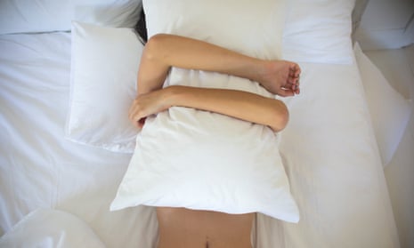 Woman covering herself with pillow