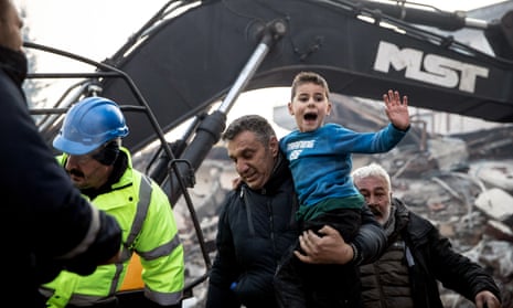 Rescue workers carry eigh-year-old survivor Yigit at the site of a collapsed building 52 hours after an earthquake struck on 8 February 2023 in Hatay, Turkey.