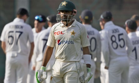 The Pakistan captain, Babar Azam, walks off the pitch after being run out for 78