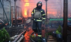 A Ukrainian firefighter at a hardware store following Russian strikes in Kharkiv.