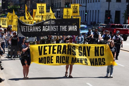 Protesters carry banners reading ‘Veterans say no more rich man’s wars’ and ‘Veterans against the war’