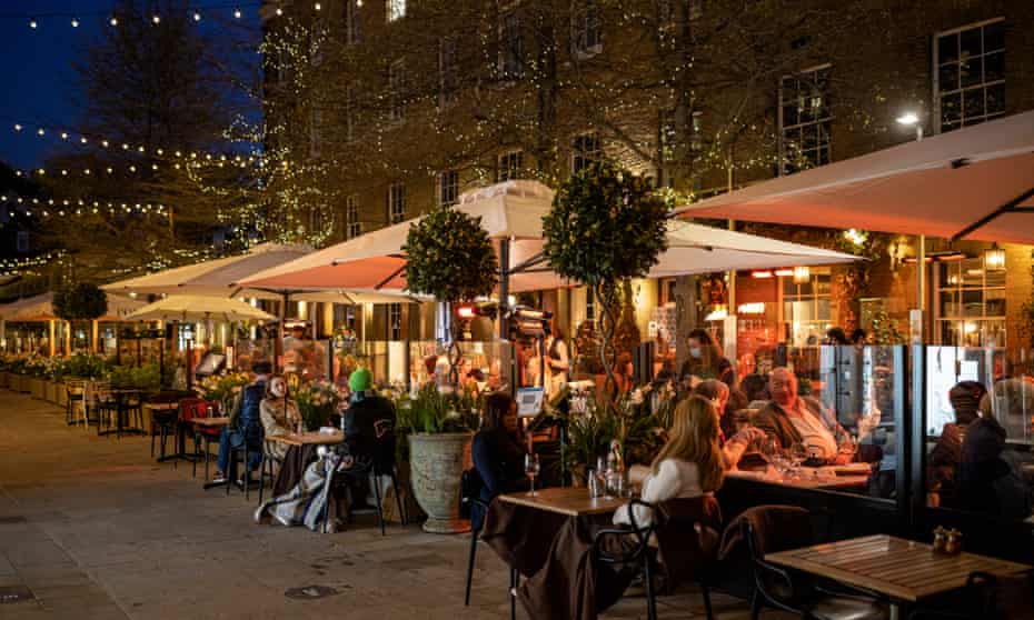 Diners eating outdoors at a restaurant in London.